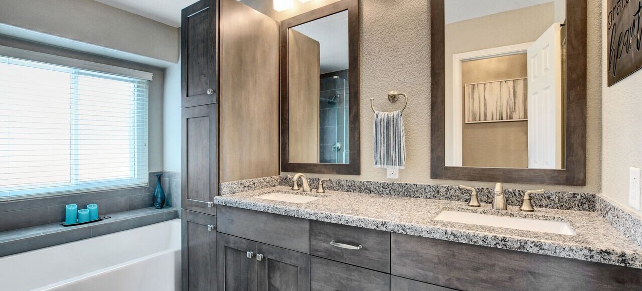 a bathroom remodel with a sink and mirrors modern look