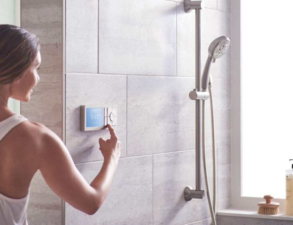 A Woman in the changing the setting of her shower